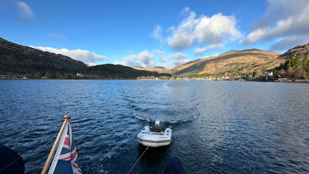 Digny being dragged behind boat