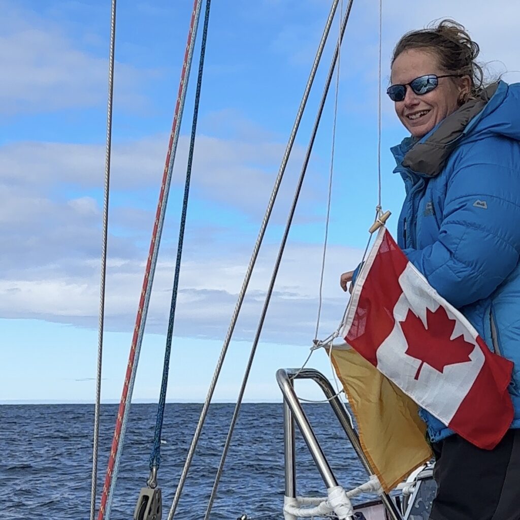 Sarah raising the Canadian flag