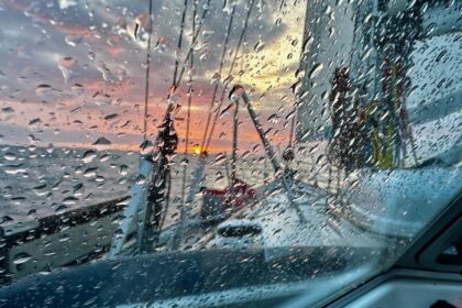 Picture of the wet sprayhood and the sunset at the north sea