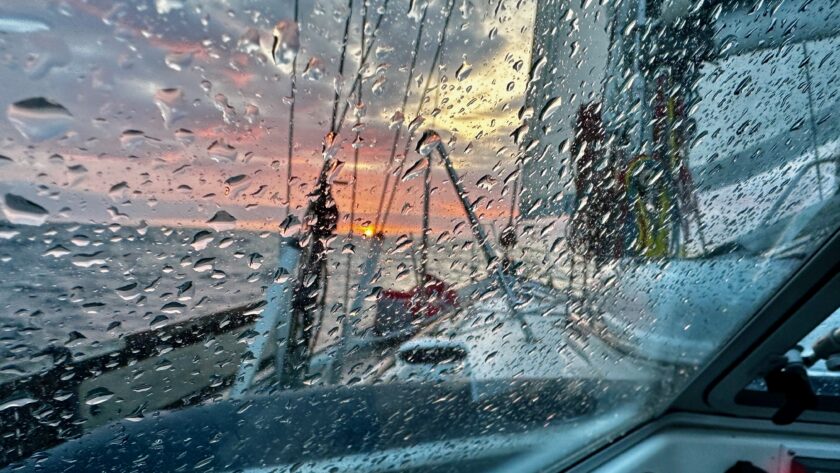 Picture of the wet sprayhood and the sunset at the north sea