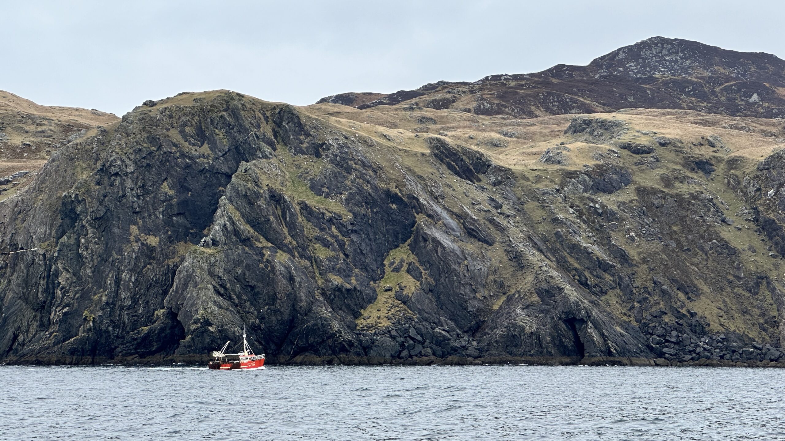 Beautiful cliffs and little fishing boat